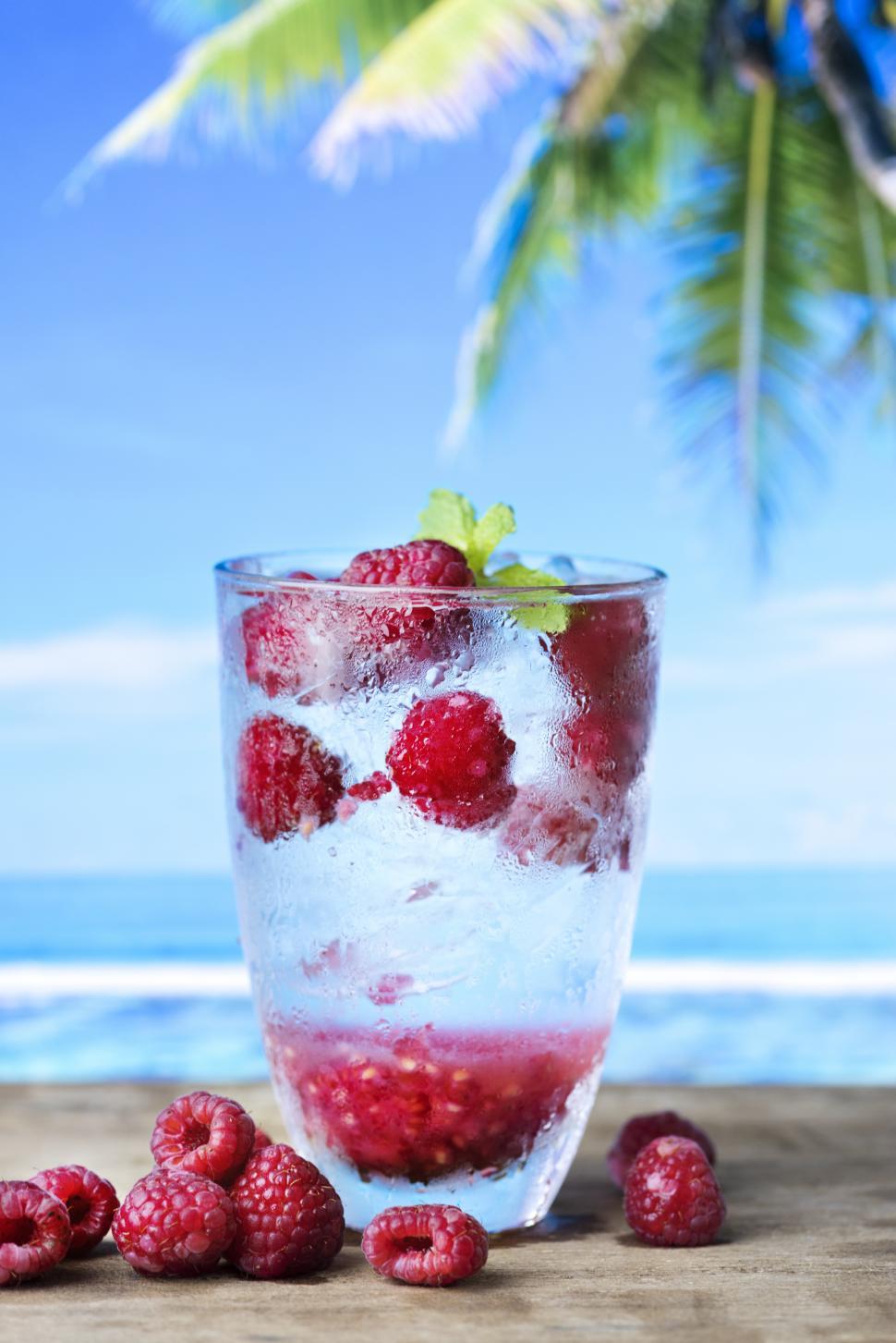 Free Image of Close up of a glass of chilled beverage garnished with raspberries 