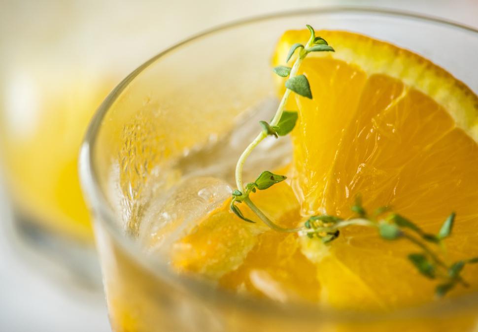 Free Image of Close up of chilled beverage in a glass garnished with orange slices 