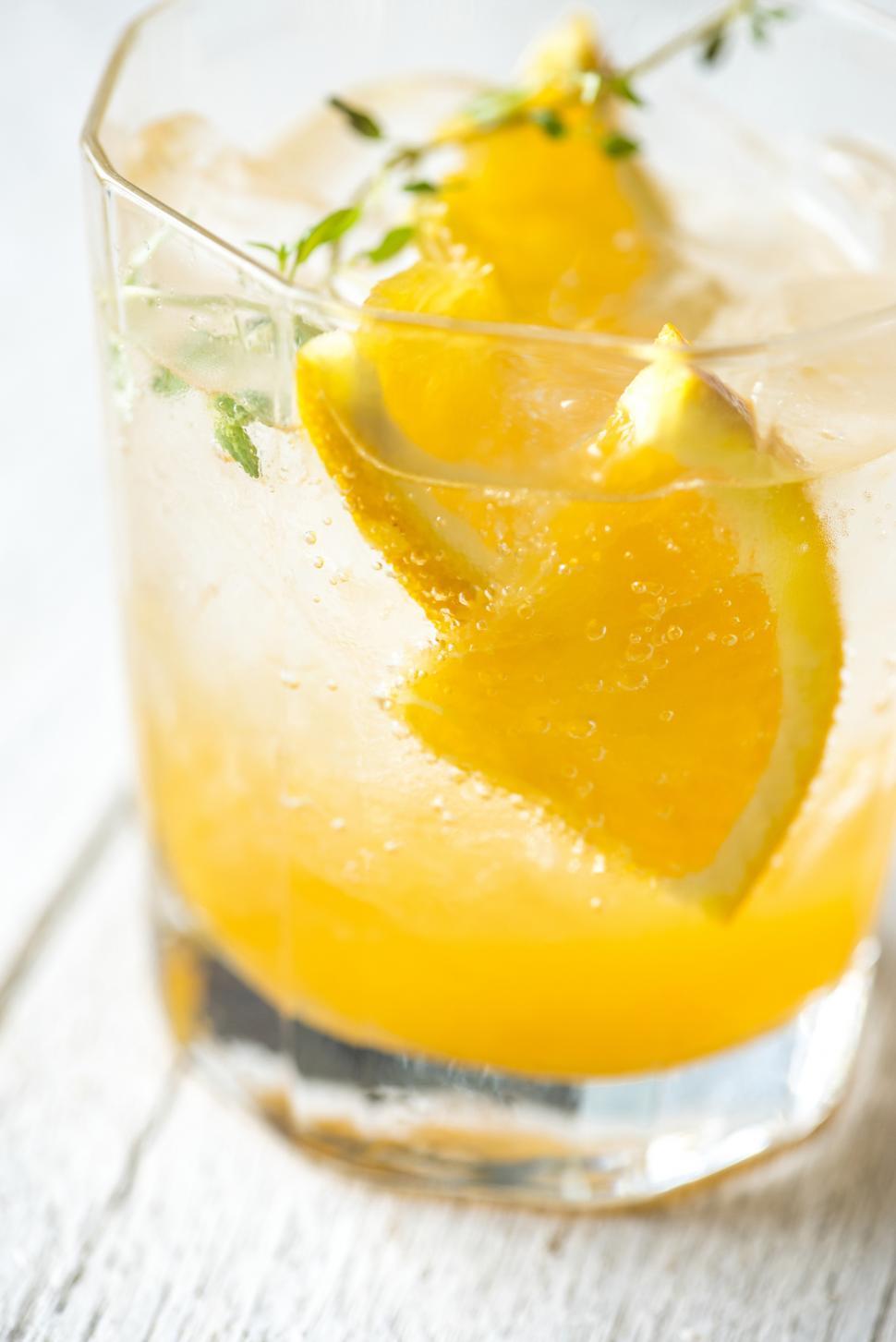 Free Image of Close up of fresh beverage in a glass garnished with orange slices 