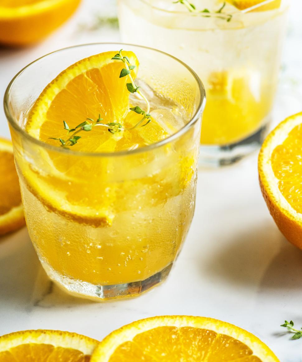 Free Image of Close up of chilled beverage in glasses garnished with orange slices 