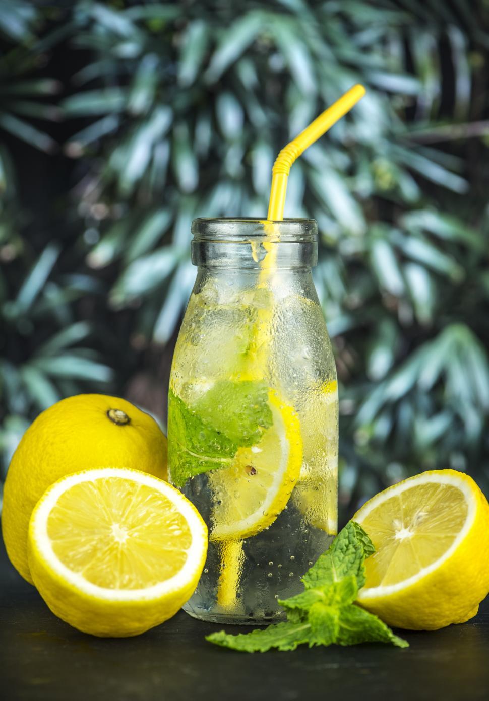 Free Image of Close up of chilled lemonade in a bottle with yellow straw 