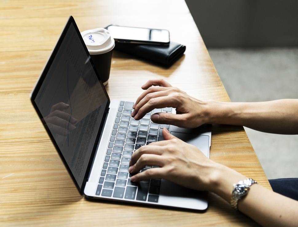 Free Image of Close up of a woman s hands typing on a compact laptop 