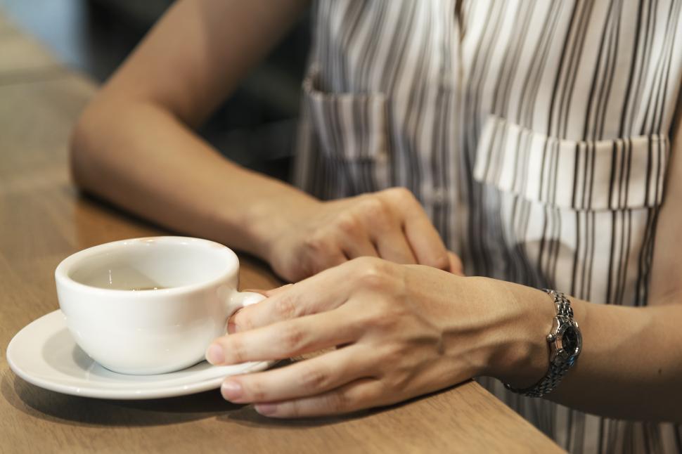 Free Image of Close up of a woman holding an empty cup of coffee 