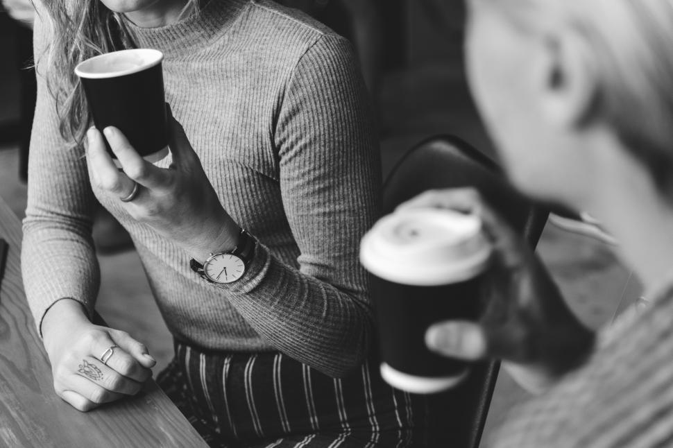 Free Image of A young woman hand holding a travel coffee cup 