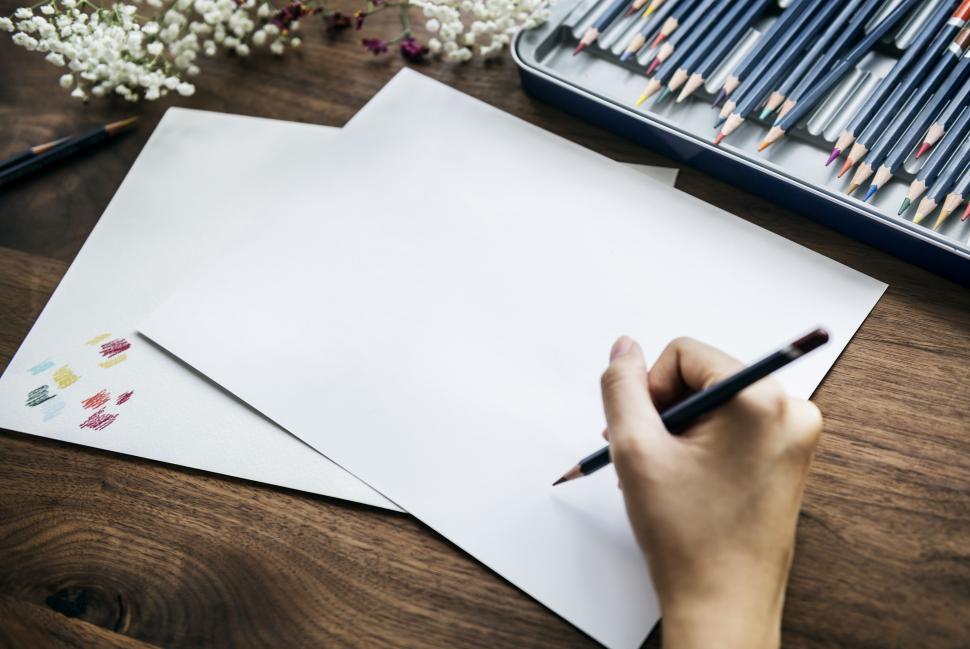 Free Image of Close up of a hand sketching with color a pencil 