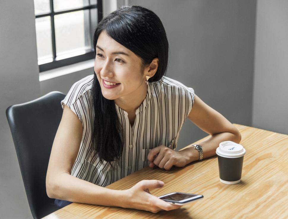 Free Image of A woman operating her mobile phone 