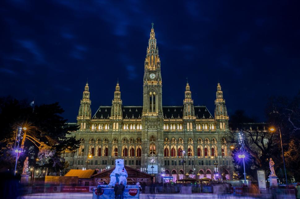 Free Image of Illuminated Clock Tower on Large Building at Night 