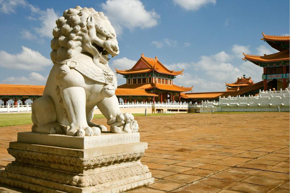 Free Image of Statue of a Lion in Front of a Building 