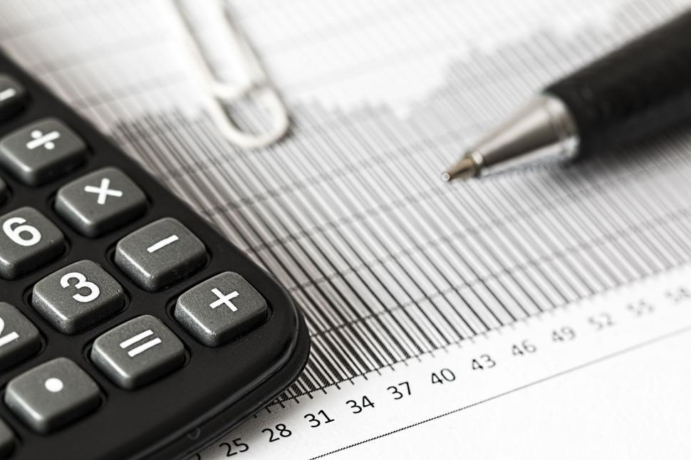 Free Image of Calculator and Pen on Top of Graph Paper 