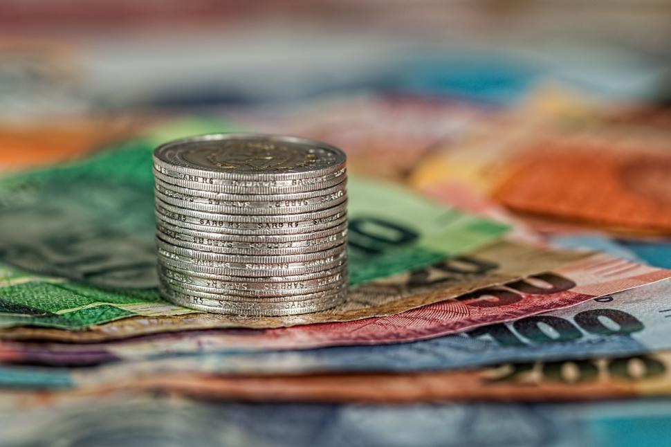 Free Image of Stack of Coins on Pile of Money 