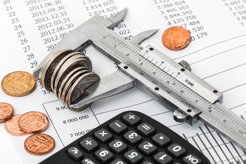 Free Image of Calculator, Coins, and a Calculator on Top of A 