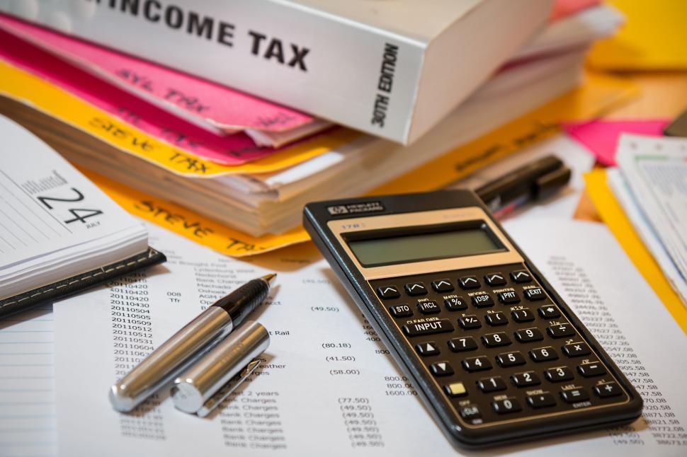 Free Image of Calculator on Top of Pile of Books 