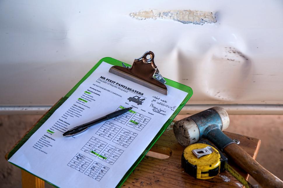 Free Image of Clipboard With Pen and Hammer 