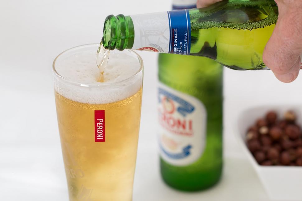 Free Image of Person Pouring Beer Into Glass 