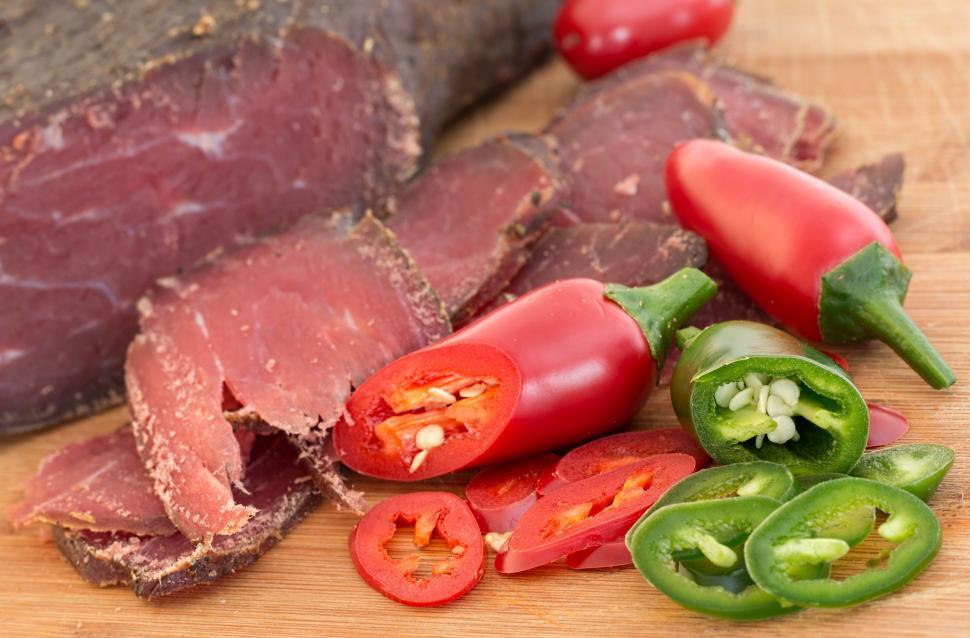 Free Image of Wooden Cutting Board With Sliced Meat and Vegetables 