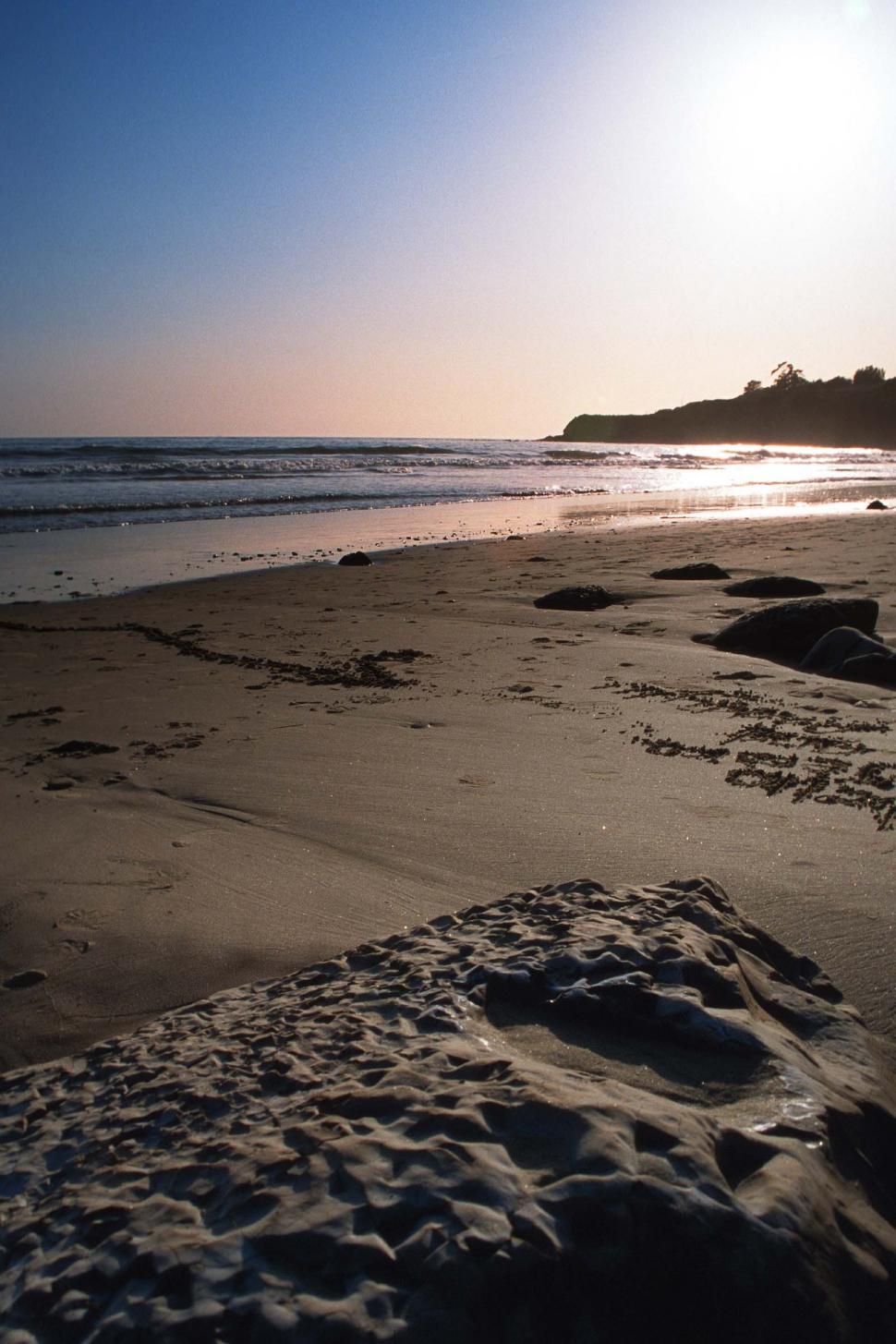Free Image of Beach sunset with rocks and sand 