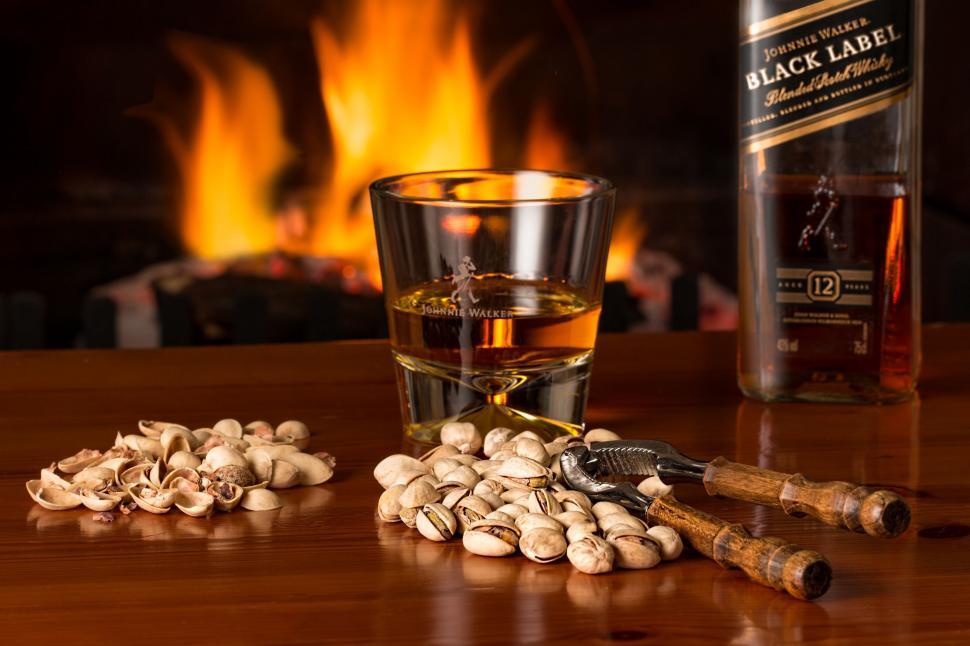 Free Image of Glass of Whiskey and Nuts on Table 