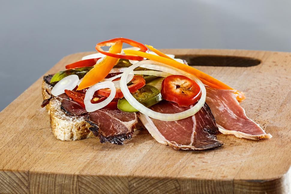 Free Image of Wooden Cutting Board With Meat and Veggies 