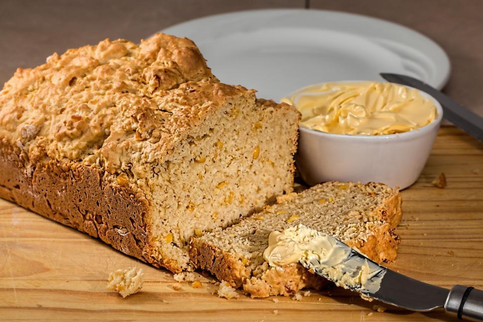 Free Image of Loaf of Bread on Wooden Cutting Board 