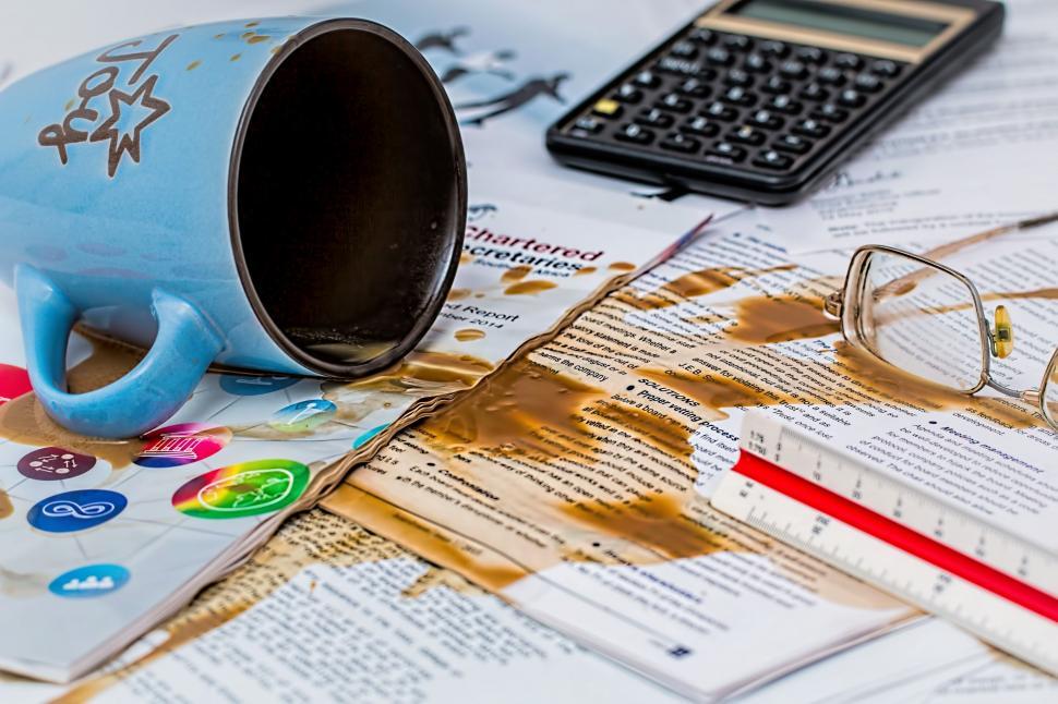 Free Image of Blue Cup on Pile of Papers 