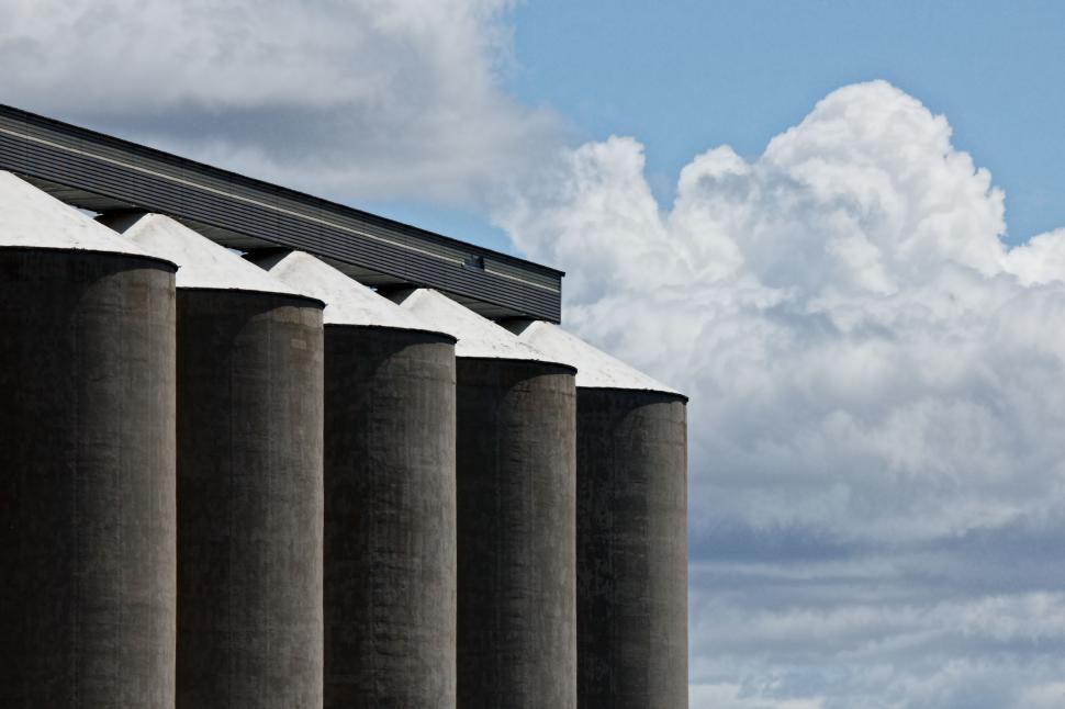 Free Image of Row of Pillars Under Cloudy Blue Sky 