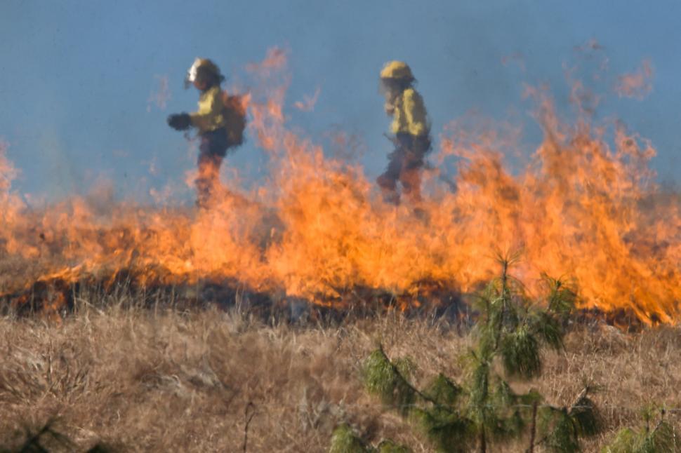 Free Image of Two Firefighters in Full Protective Gear Battling Large Fire 