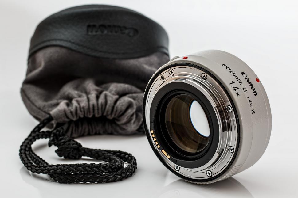 Free Image of Camera Lens Beside Black Case 