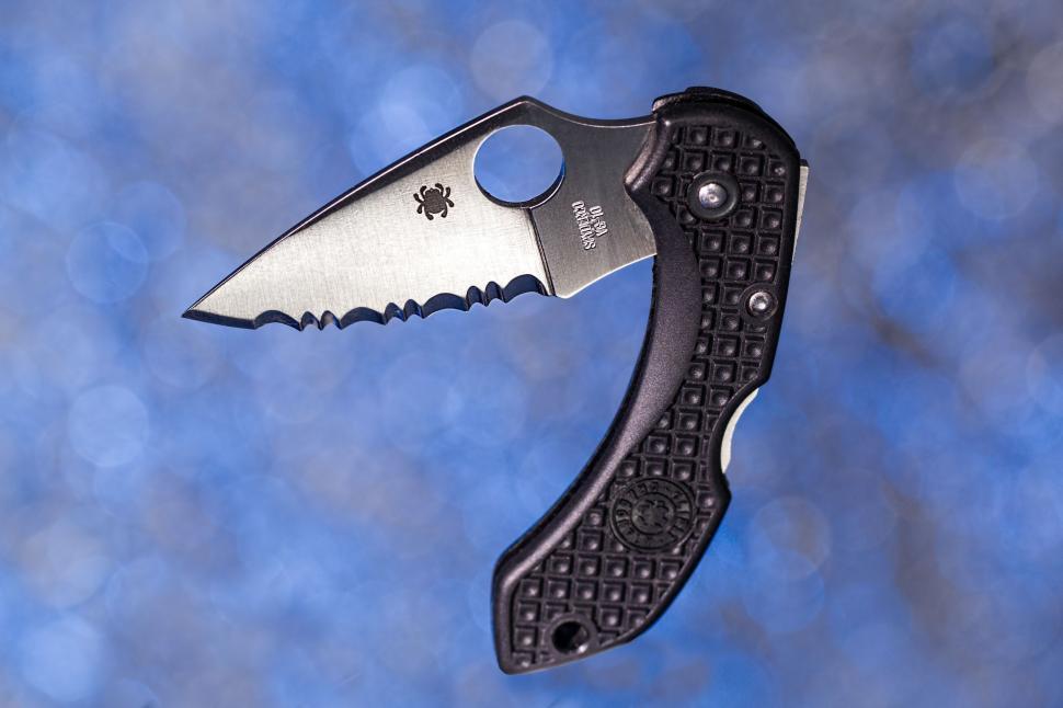 Free Image of A Knife With a Black Handle on a Blue Background 