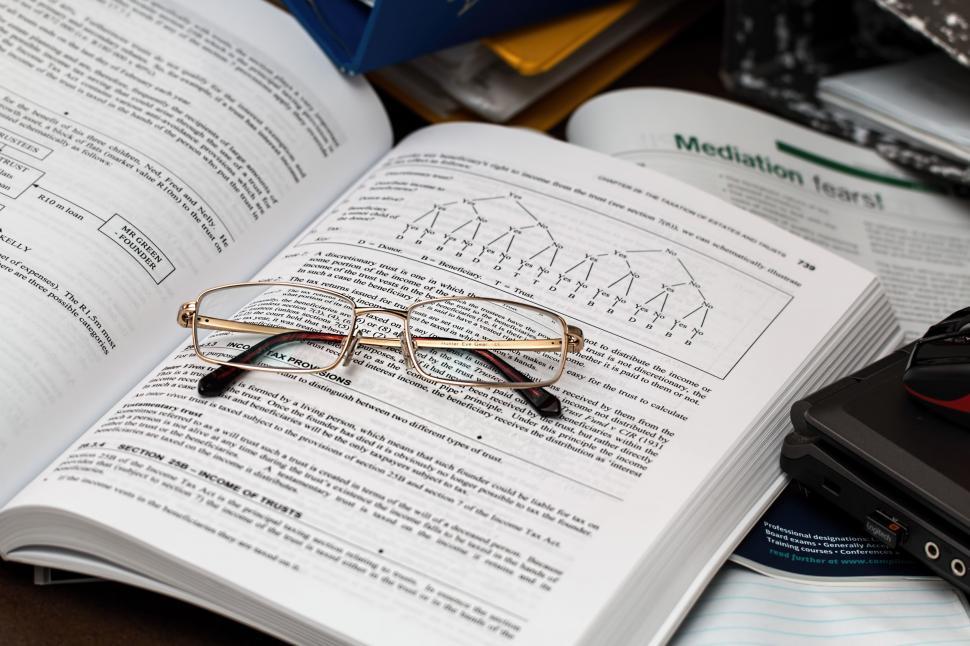 Free Image of Glasses on Open Book 