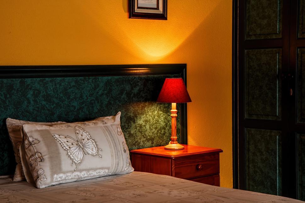 Free Image of Bedroom With Pillows And Yellow Wall 