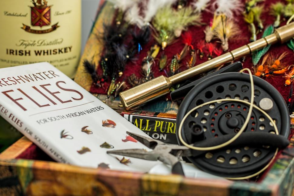 Free Image of Wine Bottle, Fly Rod, and Various Items in Box 