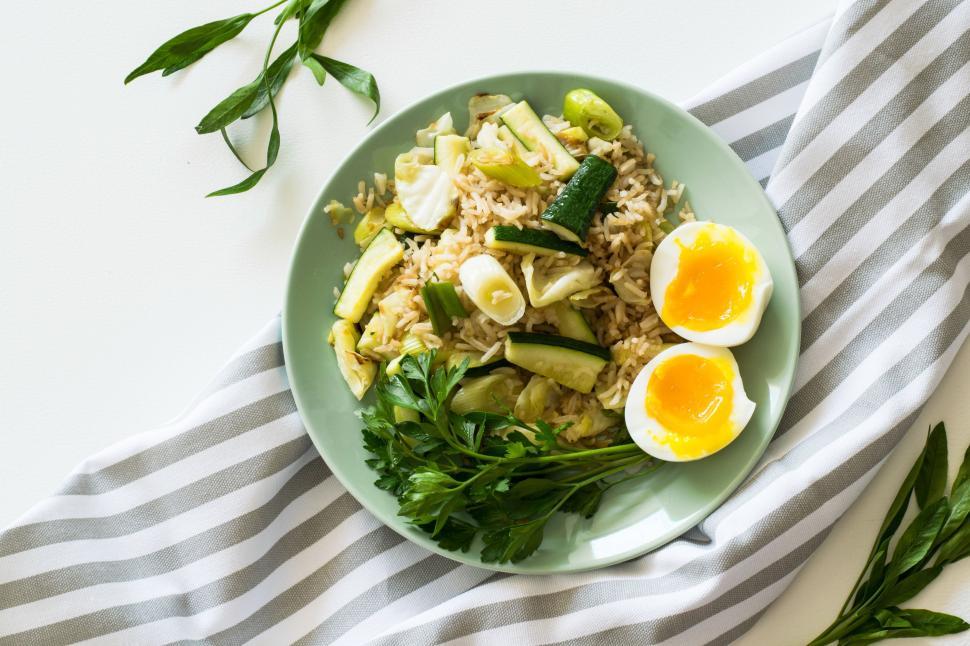 Free Image of Fried Rice and two halves of a boiled egg for lunch  