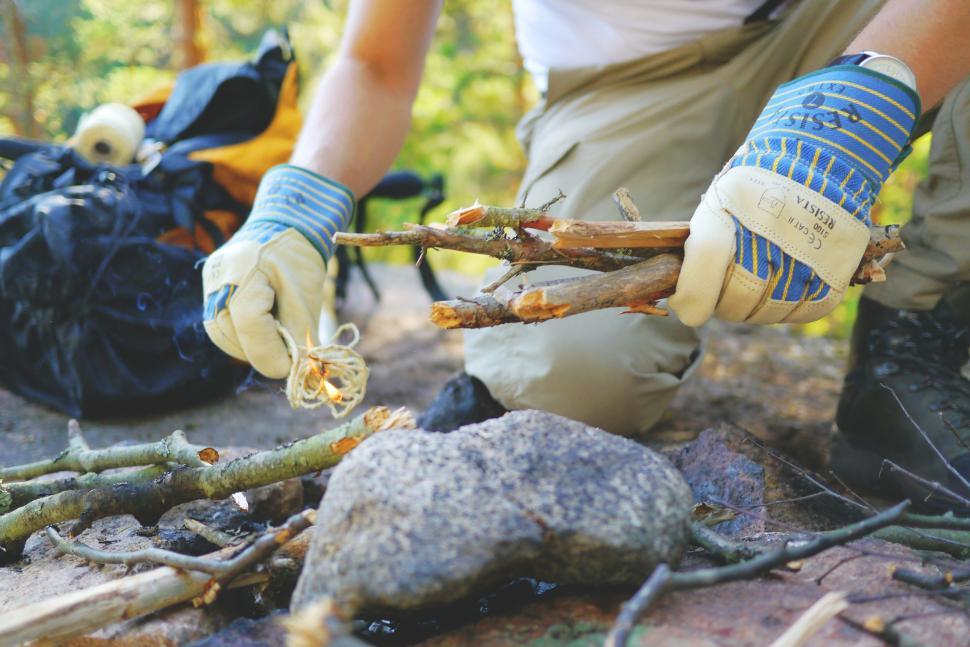 Free Image of Hands with gloves starting campfire  