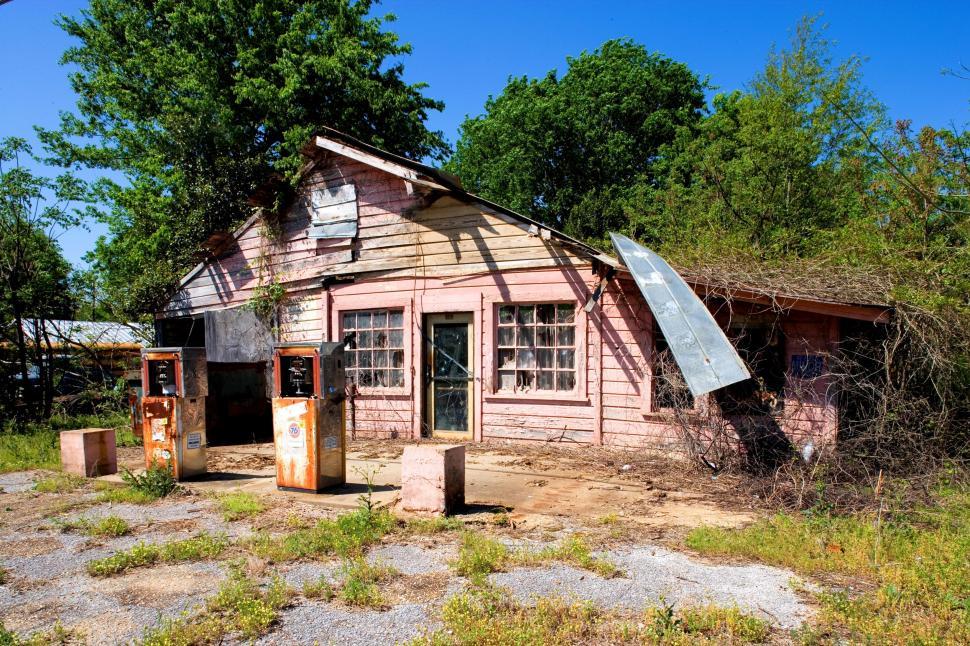 Free Image of Abandoned Petrol Station surrounded by trees  