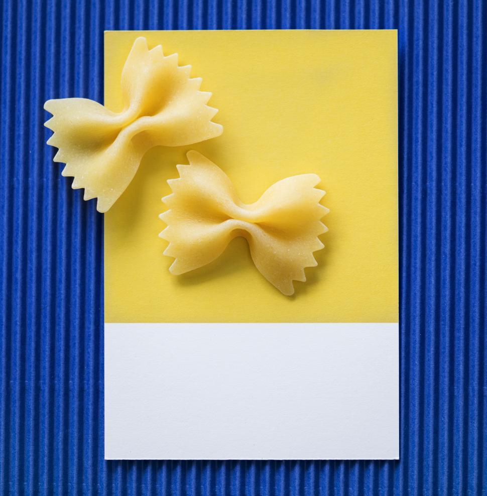 Free Image of Flat lay of Farfalle pasta Bow-tie pasta on spaced cardboard frame 