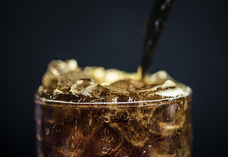 Free Image of Iced cola drink being poured into a pint glass 
