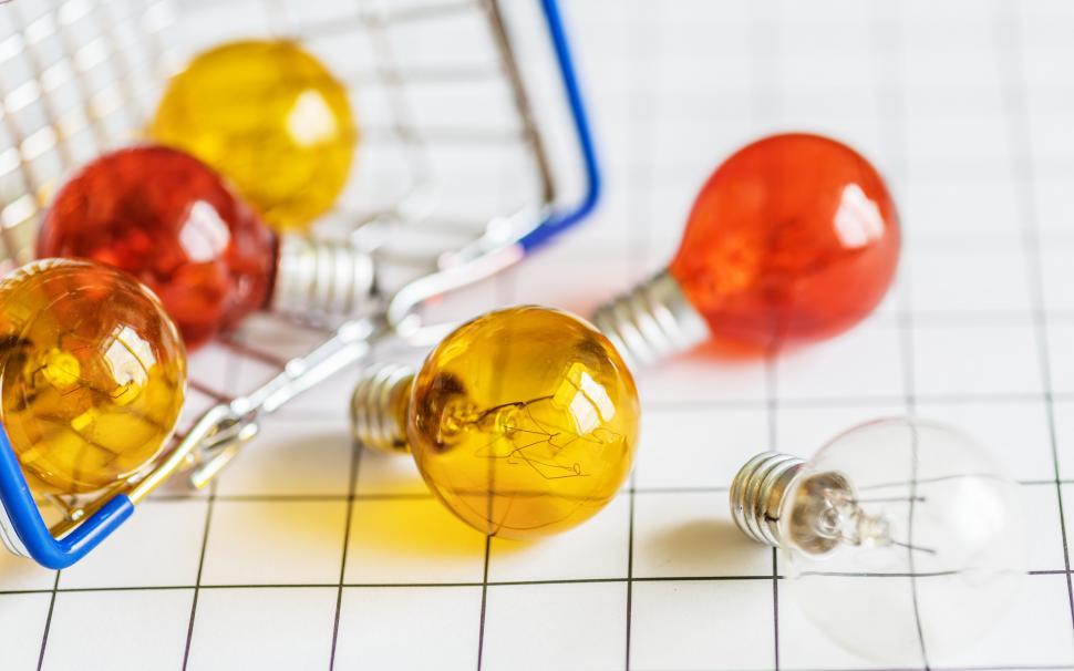 Free Image of Close up of miniature light bulbs fallen out of a steel wire basket 