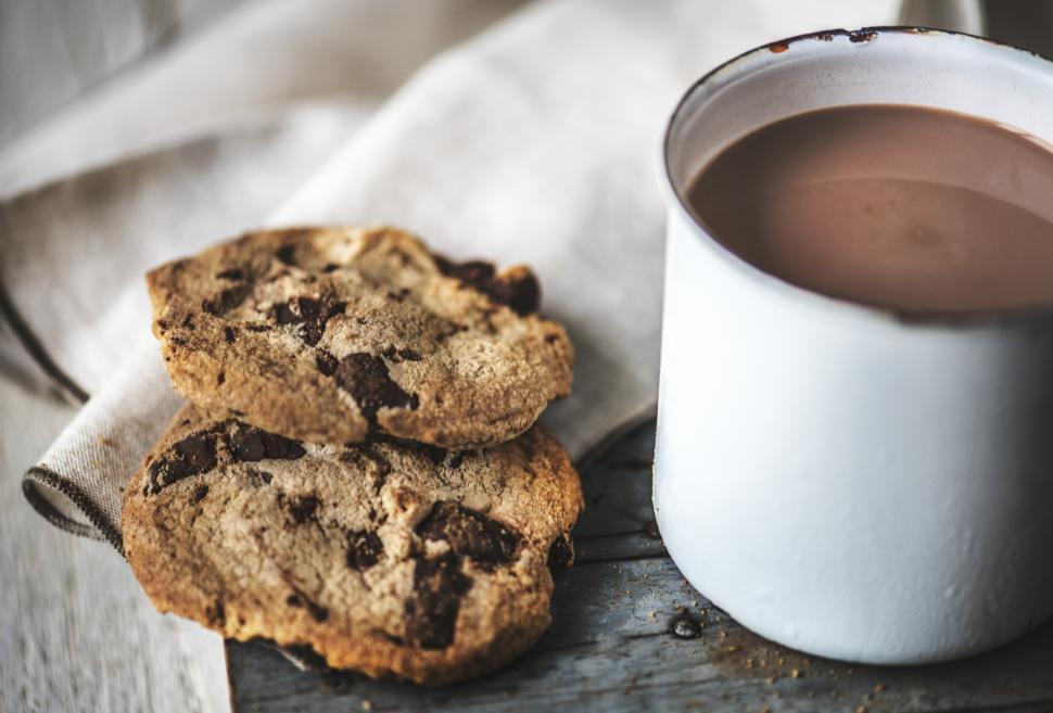 Free Image of Close up of chocolate chip cookies and hot chocolate in a mug 