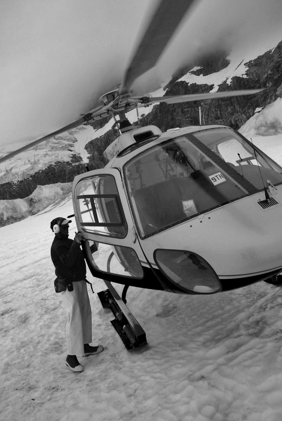 Free Image of Helicopter and Pilot in Snow  