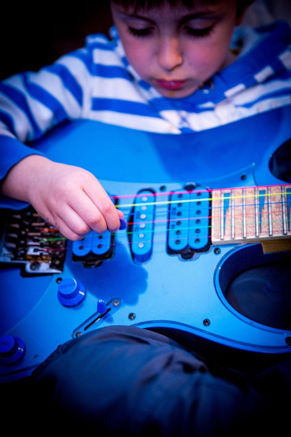 Free Image of Little boy with guitar 