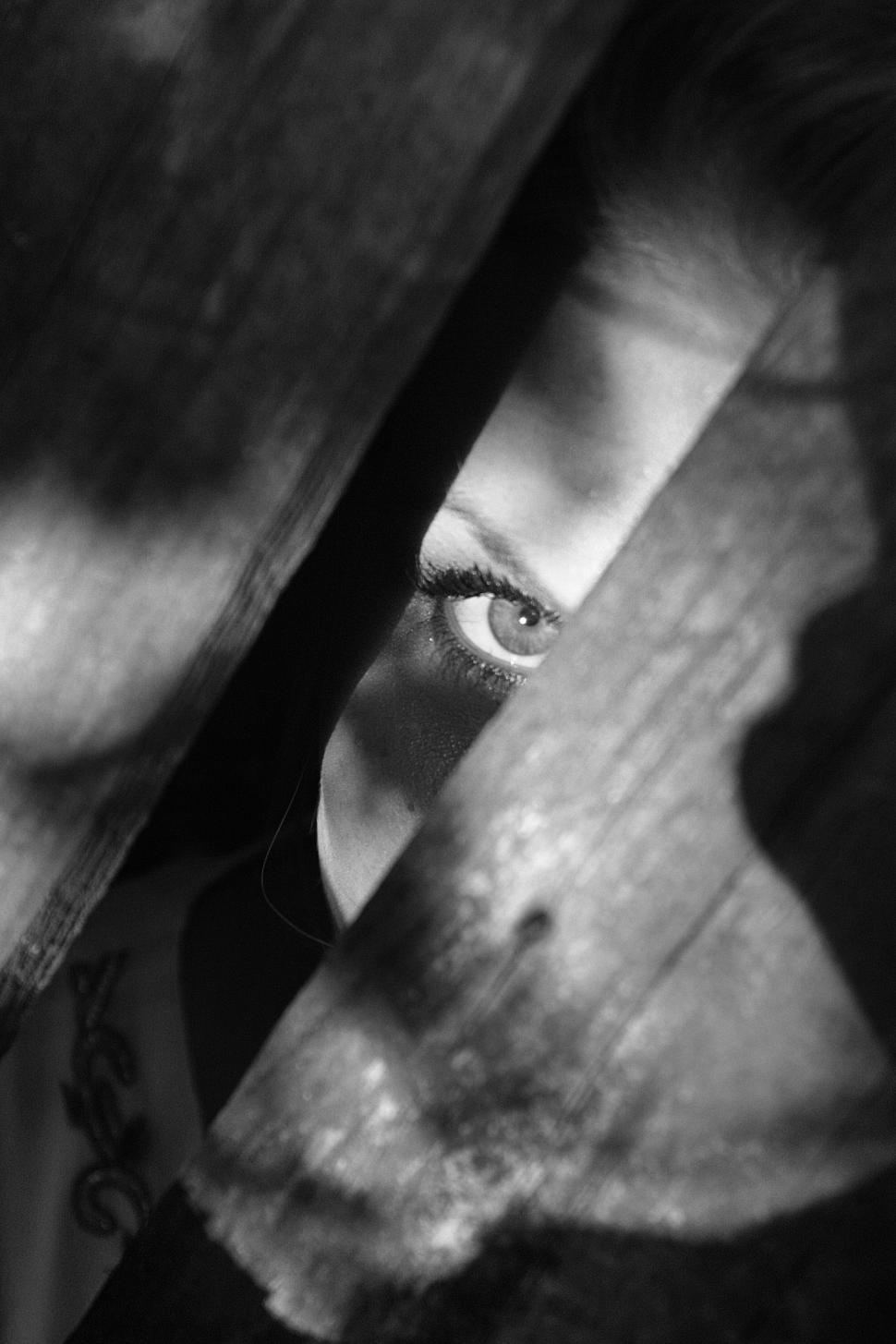 Free Image of Woman looking from hole while hiding  