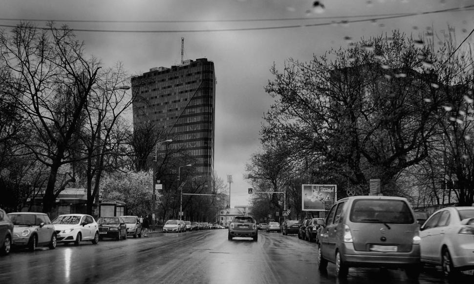 Free Image of Black and White view of Road with cars in rain  