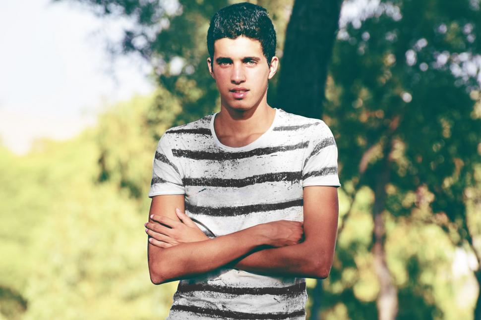 Free Image of Young Man posing for camera in the park  