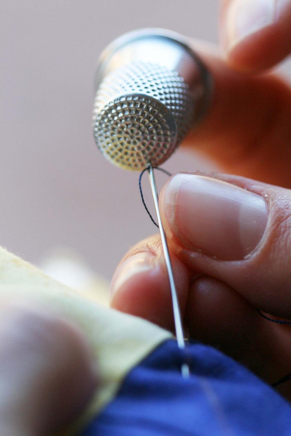 Free Image of Thimble pushing a needle 