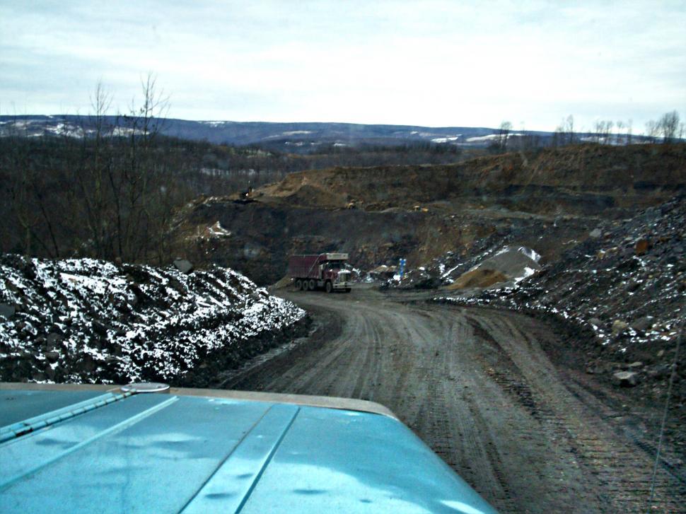 Free Image of Truck Driving Down Dirt Road 