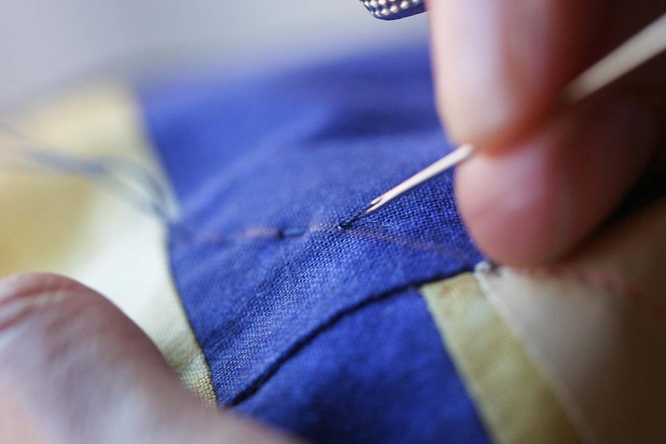 Free Image of Close Up of Person Using Needle 