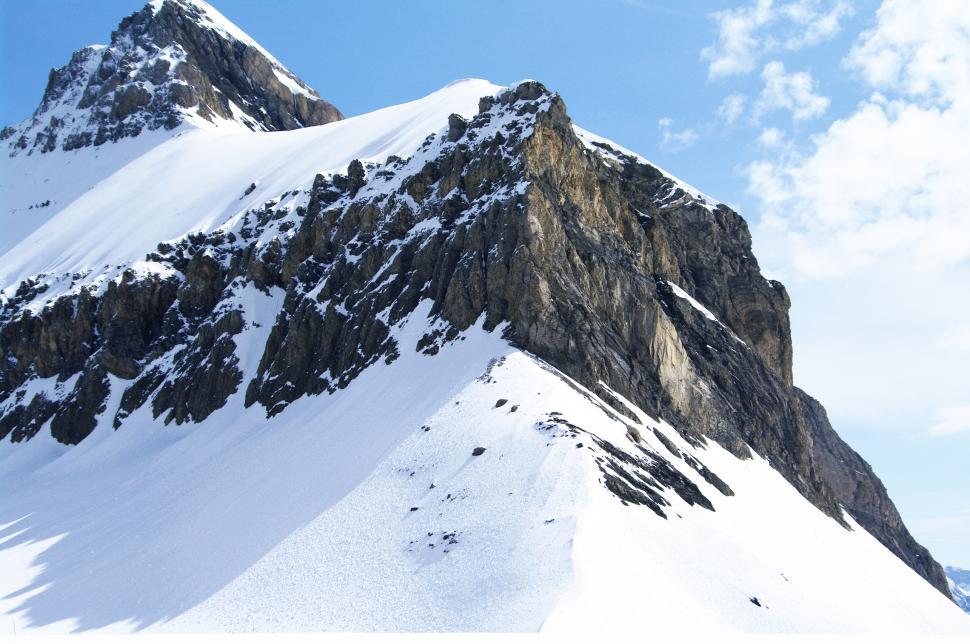 Free Image of Majestic Snow-Covered Mountain Under Blue Sky 