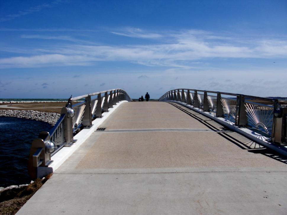 Free Image of Person Walking Across Bridge Over Water 