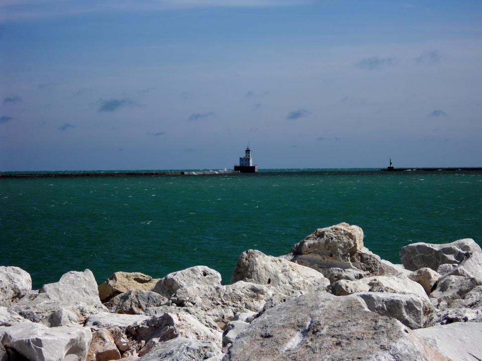 Free Image of Large Body of Water Surrounded by Rocks 