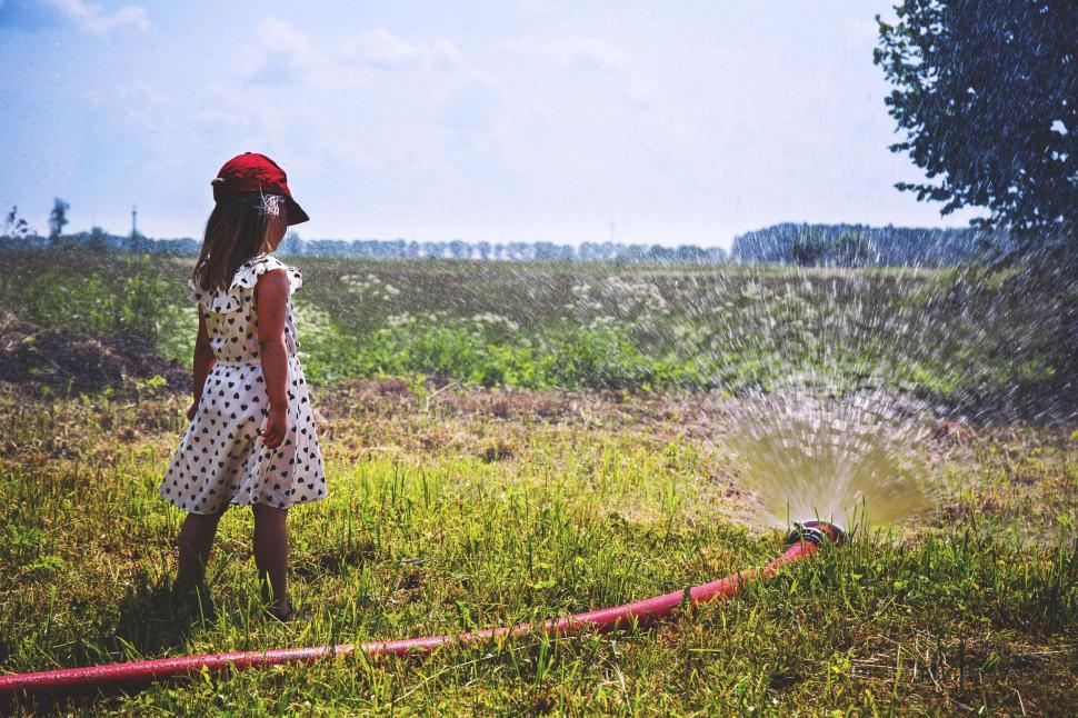 Free Image of Girl Child and Garden Sprinkler  